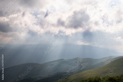Sun rays illuminating slopes, Bieszczady Mountains, Poland