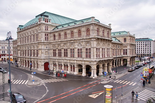 People walking in front of Vienna State Opera, named Wiener Staatsoper in Deutsch, Austrian opera house on Albertinaplatz in Vienna, Austria