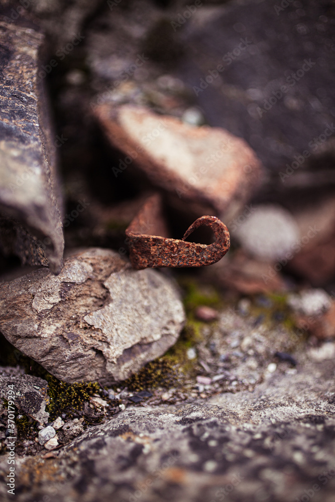 Rusty iron on stone pile