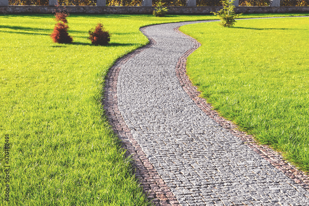 Textured background stone pathway in green park