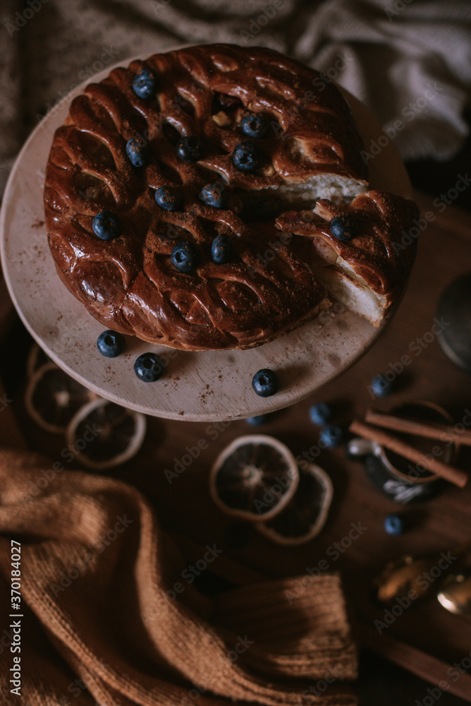 Still life of apple pie, berries, coffee and lemons on wooden tray Still life of apple pie, berries, coffee and lemons on wooden tray