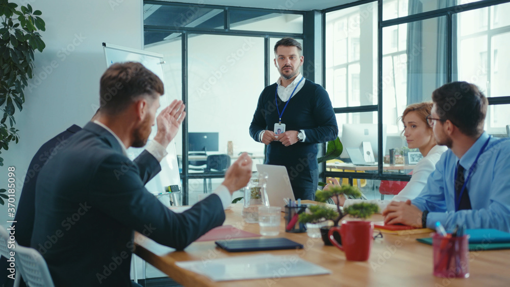Fototapeta premium Caucasian businessman presenting financial report presentation explaining charts on whiteboard and answering questions. Collaboration. Business teamwork.