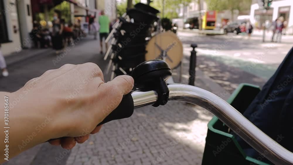 on a busy street the hand rings the bike bell on a busy street the hand rings the bike bell