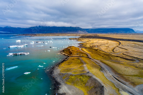 Jökulsárlón is a glacial lagoon, bordering Vatnajökull National Park in southeastern Iceland. Its still, blue waters are dotted with icebergs from the surrounding Breiðamerkurjökull Glacier.