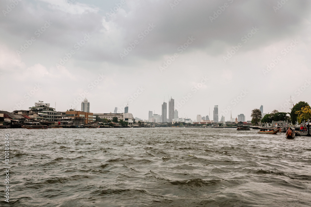 Dark mood on the river and buildings in Bangkok, Thailand