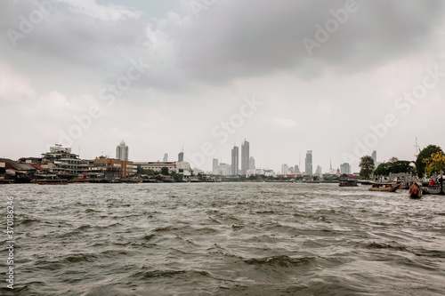 Dark mood on the river and buildings in Bangkok, Thailand