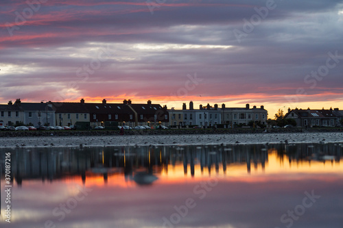 Cityscape, Sunset behind townhouses, reflection in the water, Sandymount, Dublin, Ireland