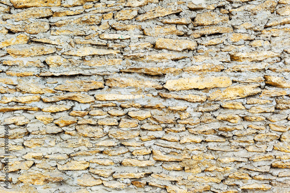 Wall built of natural stone. Can be used as background. Great background or texture. Wall built of natural stone. Can be used as background. Great background or texture.