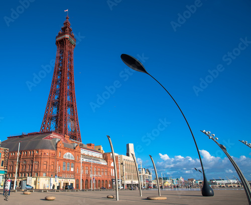 Blackpool seafront and promenade with a blue cloudless sky including the Blackpool Tower, Lancashire, UK
