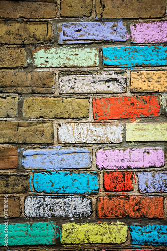 A brick wall with chalk colored bricks of many bright colors!. photo
