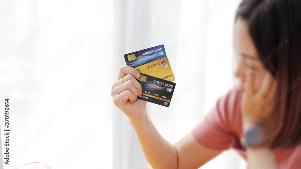 young woman holding a credit card
