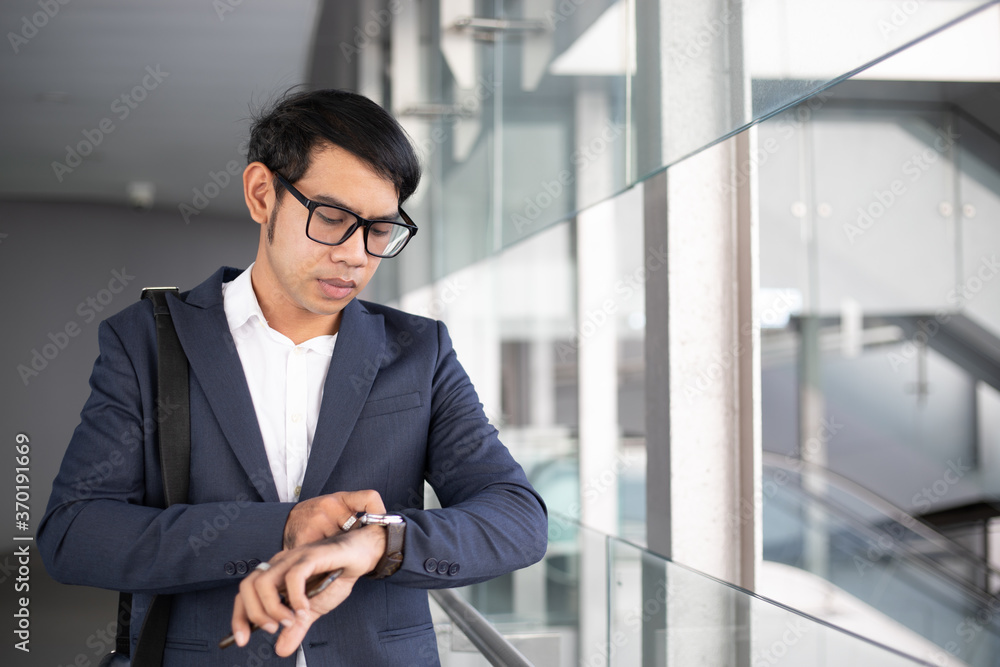 Asian businessman watching time and going to work in the morning. Asian businessman watching time and going to work in the morning.