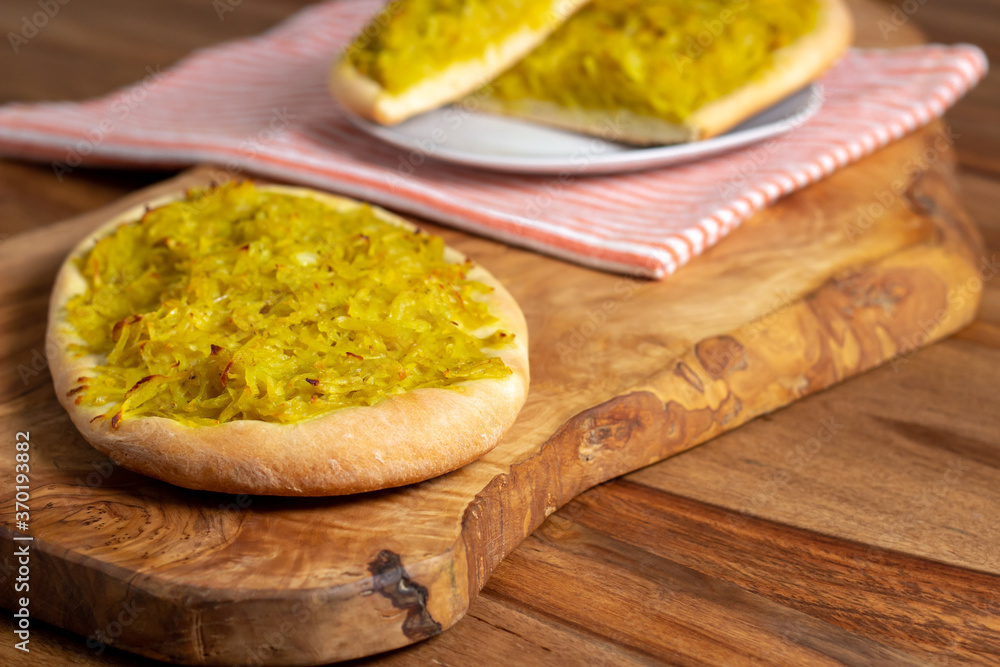 Homemade potato focaccia on a wooden cutting board. Homemade potato focaccia on a wooden cutting board.