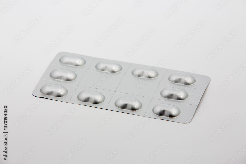 Heap of medical pills in white, orange and other colors. Pills in plastic package. Concept of healthcare and medicine. Heap of medical pills in white, orange and other colors. Pills in plastic package. Concept of healthcare and medicine.