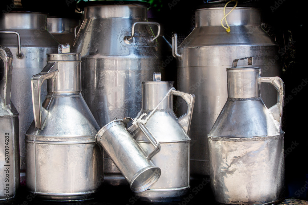 Bucket of milk from the farm. Aluminum bidon for milk storage stands. Bucket of milk from the farm. Aluminum bidon for milk storage stands.