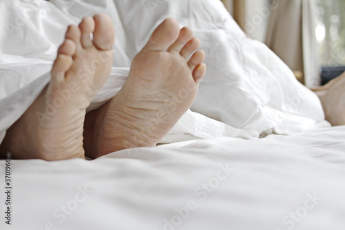 Feet on bed, relaxation concept