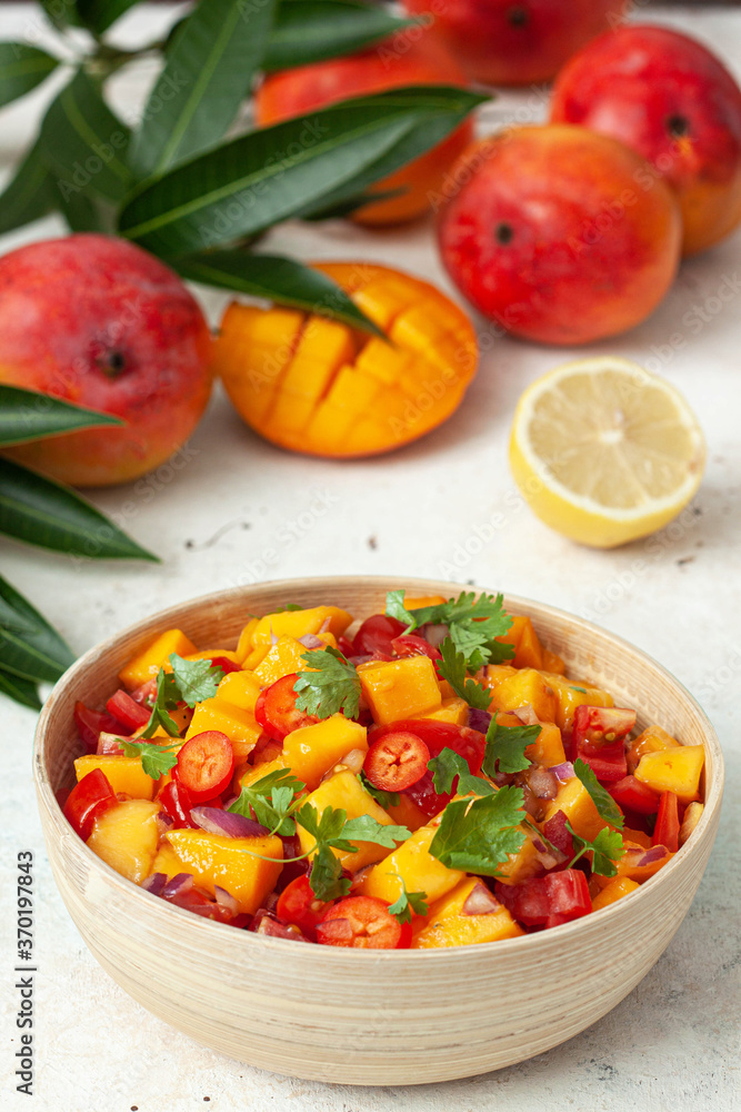 Fresh salad with mango, red pepper, tomatoes and cilantro. Fresh salad with mango, red pepper, tomatoes and cilantro.