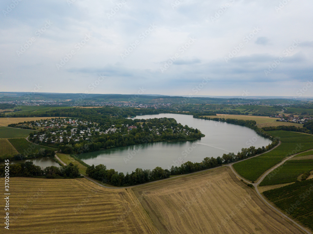 Aerial of Breitenauer See (Lake Breitenau) at Loewenstein, Germany - the lake is closed for the public during the Corona Pandemic in August 2020. Aerial of Breitenauer See (Lake Breitenau) at Loewenstein, Germany - the lake is closed for the public during the Corona Pandemic in August 2020.