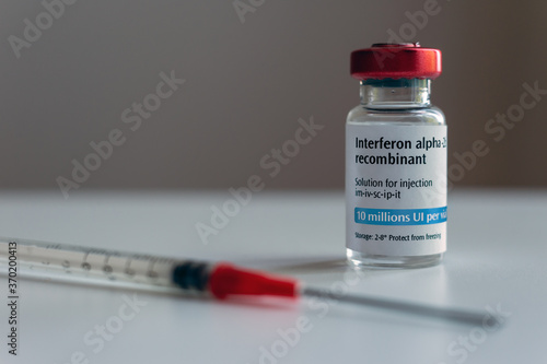 Bottle of interferon and syringe (artistic rendering) photo