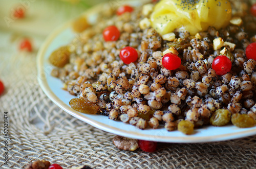 Sweet pilaf with dried fruits. Plate with kutia with dried fruits. photo