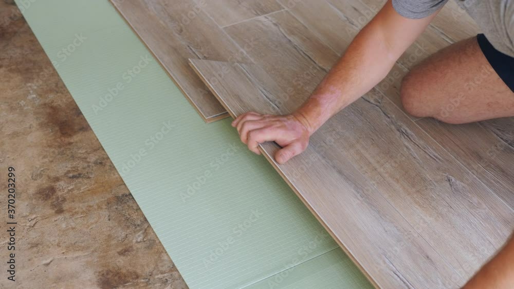 The process of laying laminate by a man in the room. The process of laying laminate by a man in the room.