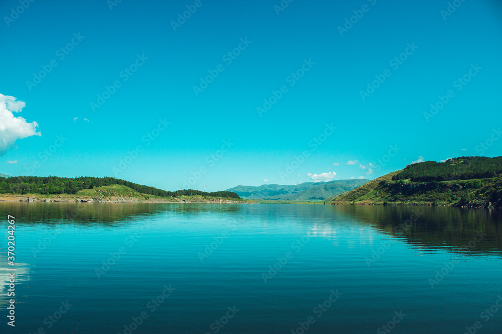 blue reservoir under blue sky