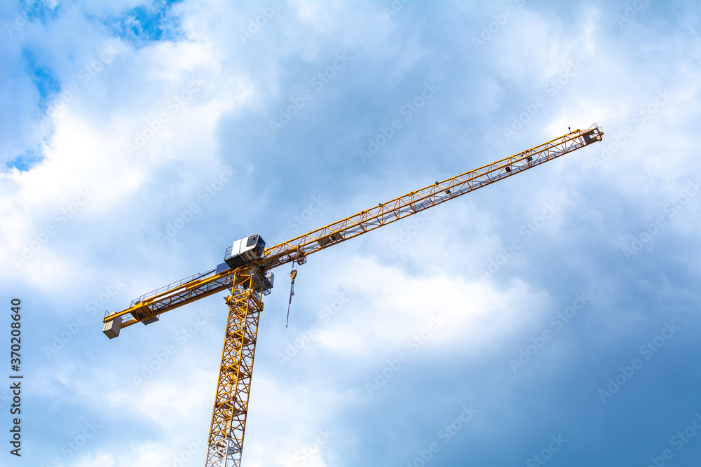 a tower crane in front of a cloudy sky a tower crane in front of a cloudy sky