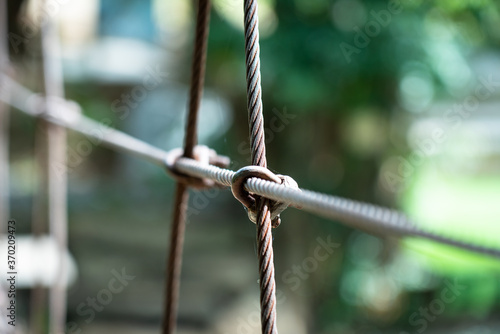 Metal wire rope bridge sling part. Close-up and selective focus on the sling part. Building material object photo.