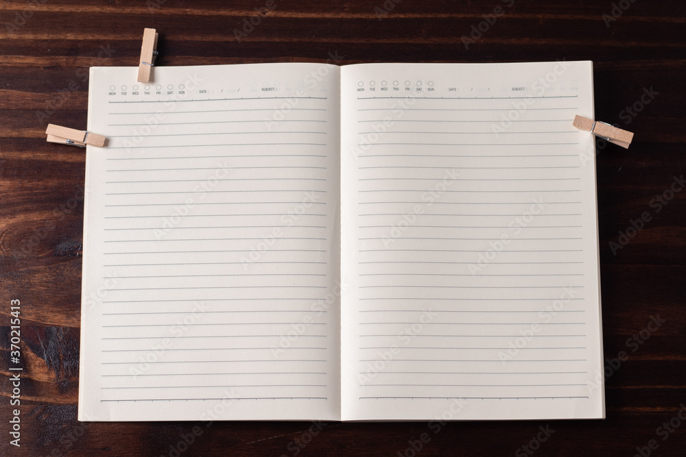 Notepad with lines on a wooden background. Copy space.