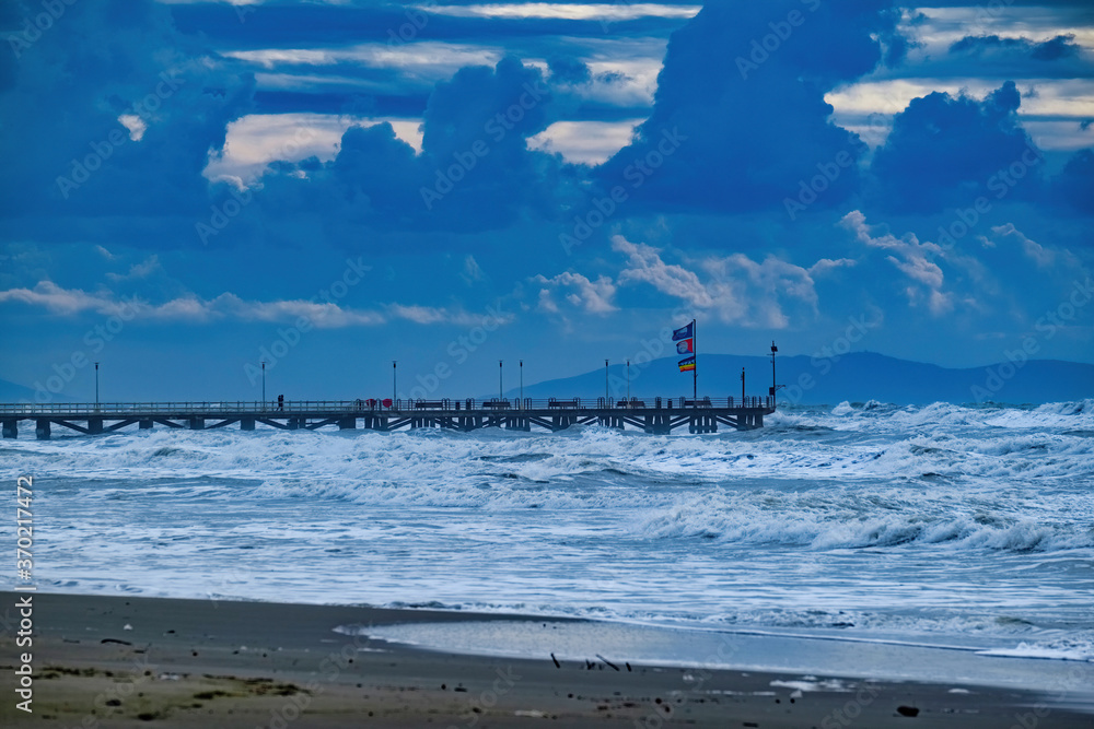 Pier and beach of Forte dei Marmi on a stormy sea day Versilia Tuscany Italy