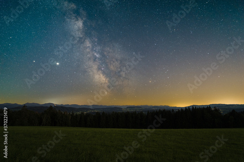 The Milky Way over the Allgovia mountains as seen from the summit a mountain near Isny in Germany.