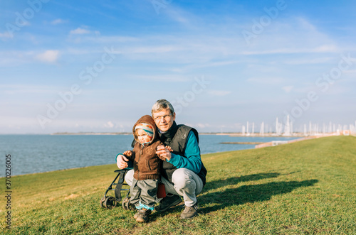 Man with toddler girl on dyke of IJsselmeer