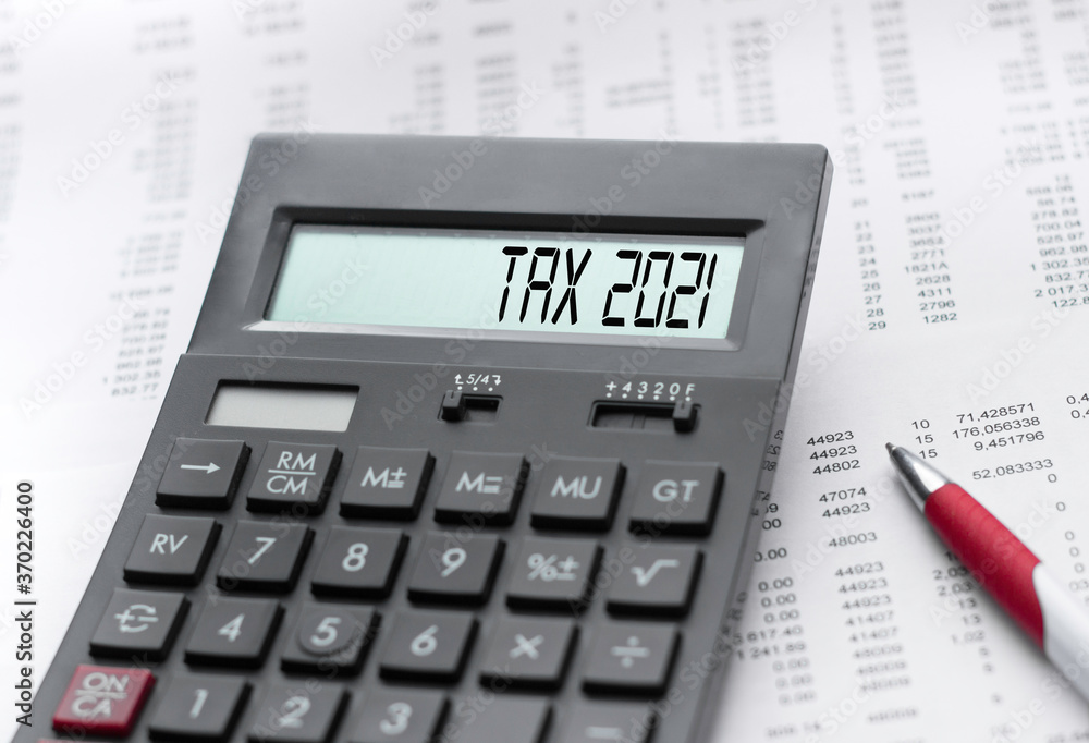 A calculator with the inscription tax 2021 . Business profit concept A calculator with the inscription tax 2021 . Business profit concept