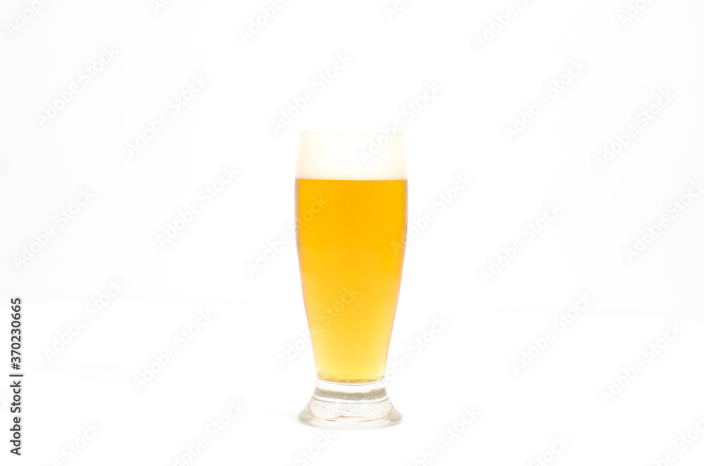 A glass of beer filled with foam centered in the image with a white background. A glass of beer filled with foam centered in the image with a white background.