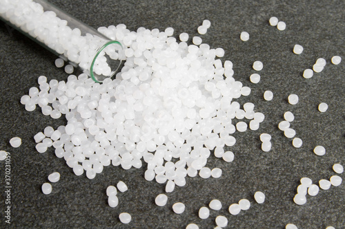 Obraz na płótnie Plastic pallets. White Polyethylene granules on a stone background. Plastic Raw material .High Density Polyethylene.