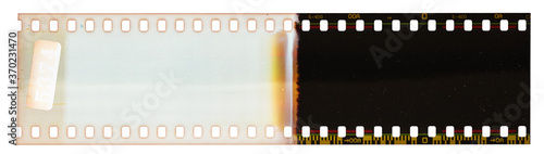 Start of 35mm negative filmstripe, first frame on white background, real scan of film material with cool scanning light interferences on the material. 