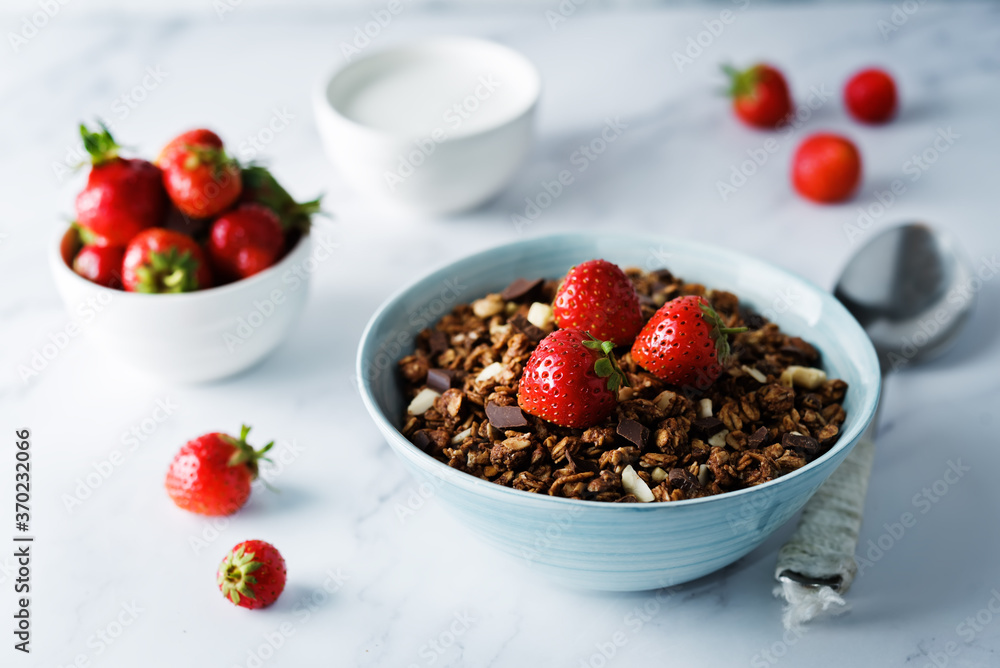 Chocolate nuts oatmeal granola with chocolate slices in a bowl Chocolate nuts oatmeal granola with chocolate slices in a bowl