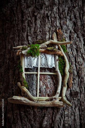 eco-friendly wooden house concept-symbol hanging on a tree