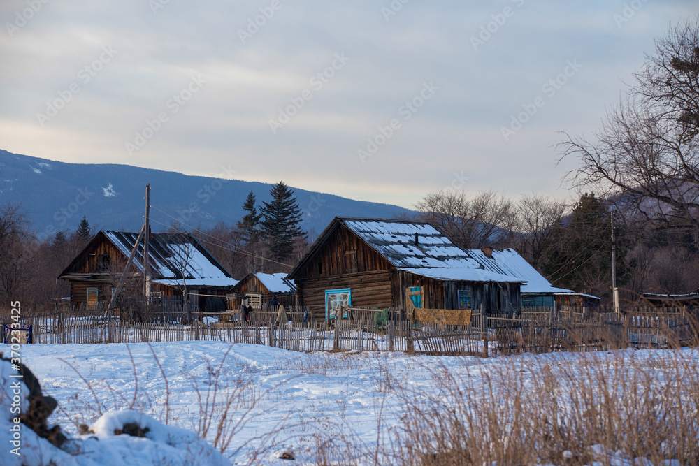 Russian village. Russian wooden house in a village in a snowy winter
