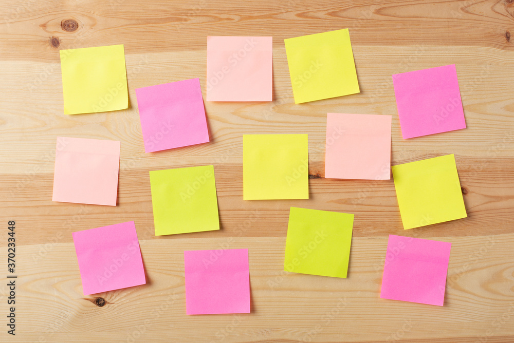 Blank colorful papers on a wooden board Blank colorful papers on a wooden board