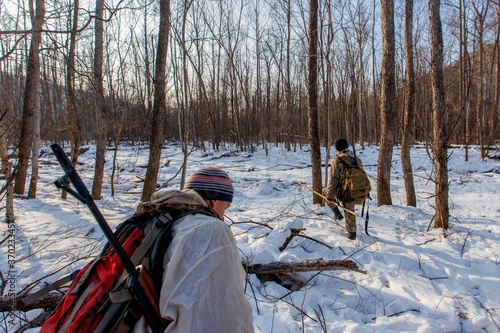 Tablou canvas January, 2016 - Agzu, Primorsky Territory - Udege hunters with guns walk through deep snow in the taiga