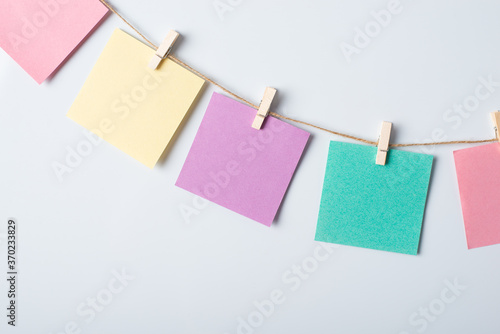 Line of colorful cards on a string with a whiteboard on the background