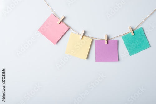 Four papers of different colour on a rope with copy space for inscription on a white board