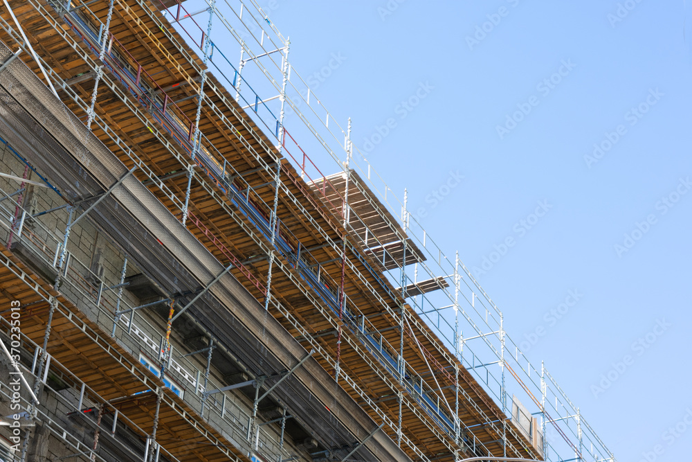Building skyscrapers or multi-storey building in scaffolding poles. Special construction for workers safety