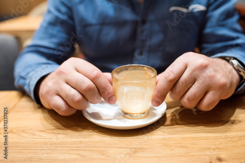 man holding an empty glass after the coffee break 
