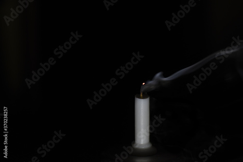 Blown candle on black background 