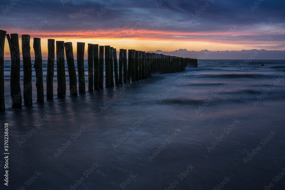 Sunset with a row of poles near Calais.