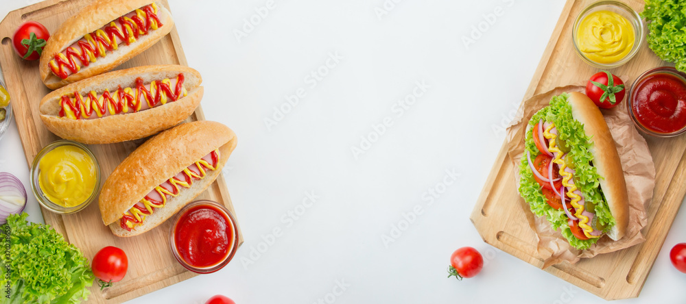 Hot dog with pickles, tomatoes and lettuce on a light background. Fast food. Calorie content of food. View from above. Space for copy. Food banner.