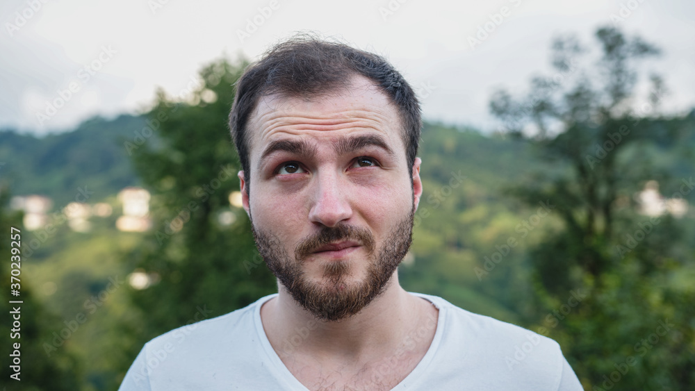 Young white-skinned handsome man with unstable problems in nature Young white-skinned handsome man with unstable problems in nature