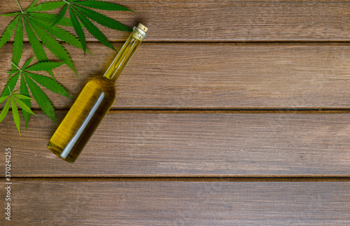 CBD oil on wooden background. The concept of a natural and organic product. Medical marijuana cbd oil.